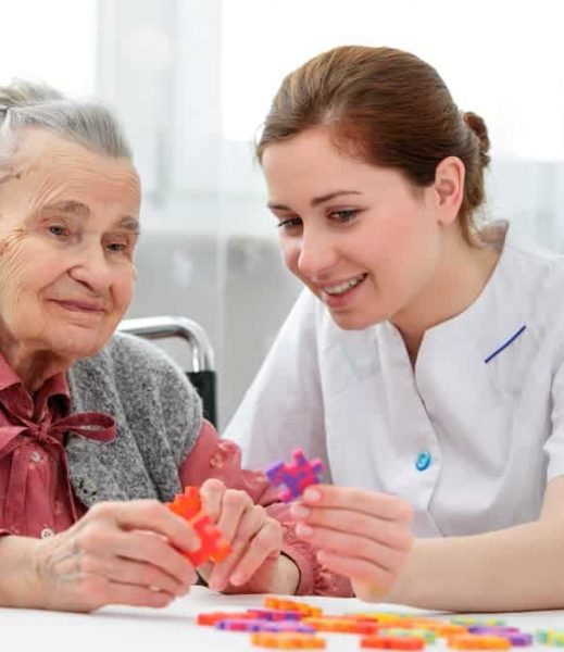 Old lady and nurse playing together — Disability Support in Wollongong, NSW