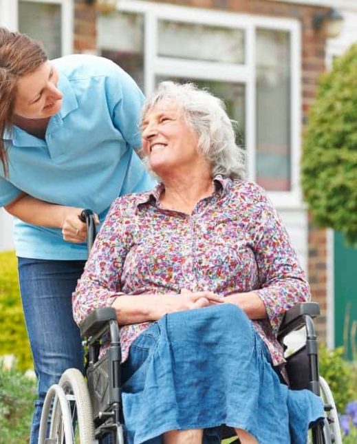 Happy old lady on a wheelchair — Disability Support in Wollongong, NSW