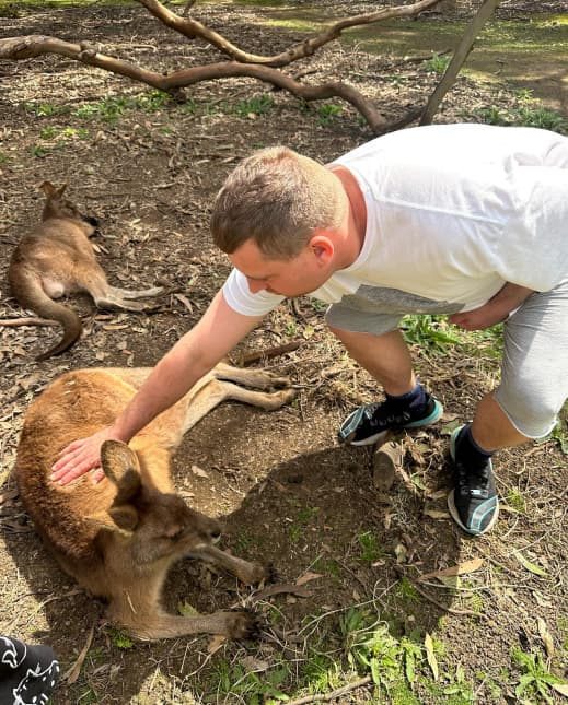 Guy petting a kangaroo — Disability Support in Wollongong, NSW